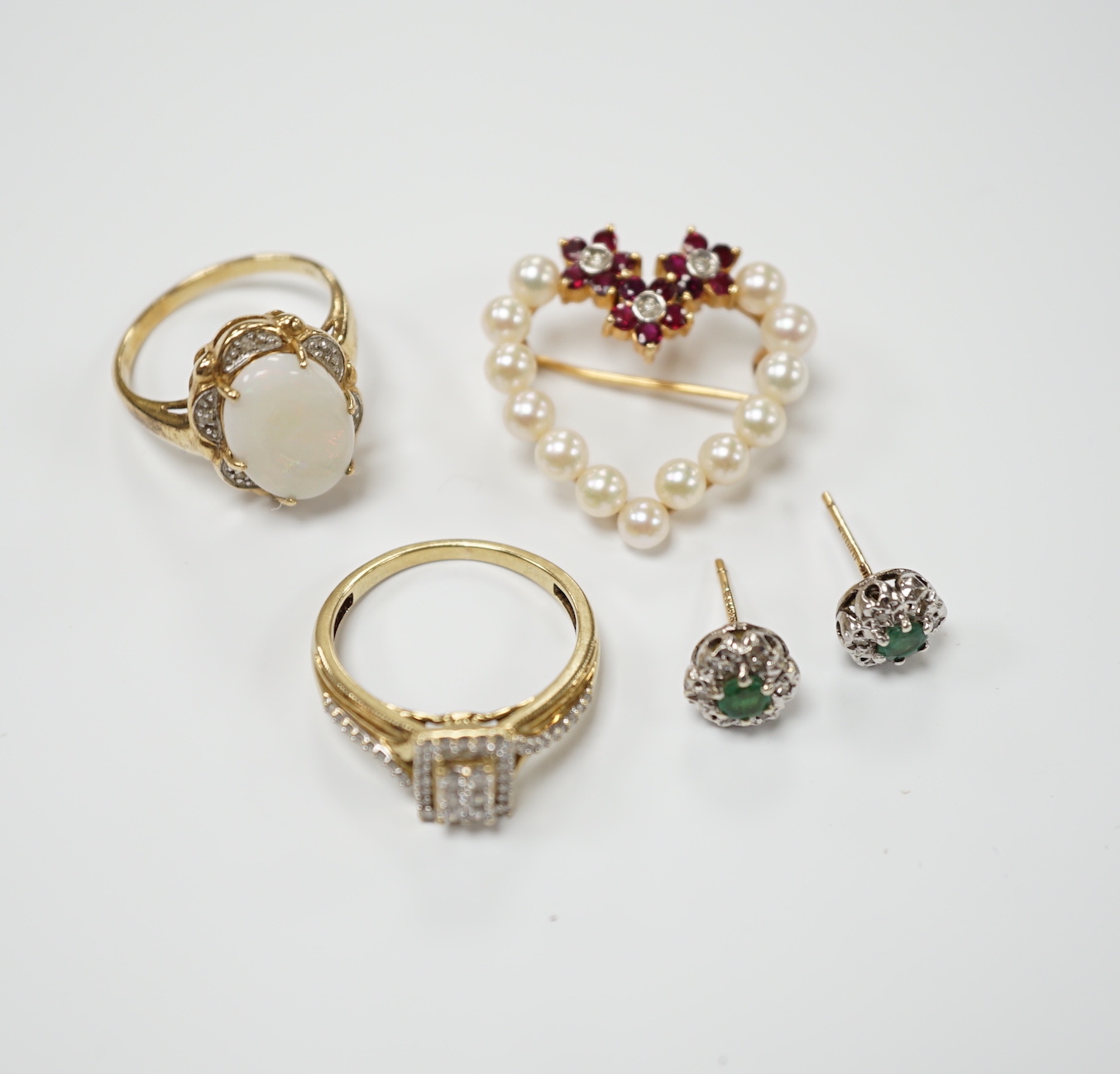 Two yellow metal and gem set rings, including diamond chip cluster and white opal and diamond chip cluster, together with a yellow metal, cultured pearl, ruby and diamond set open work heart shaped pendant brooch and a p